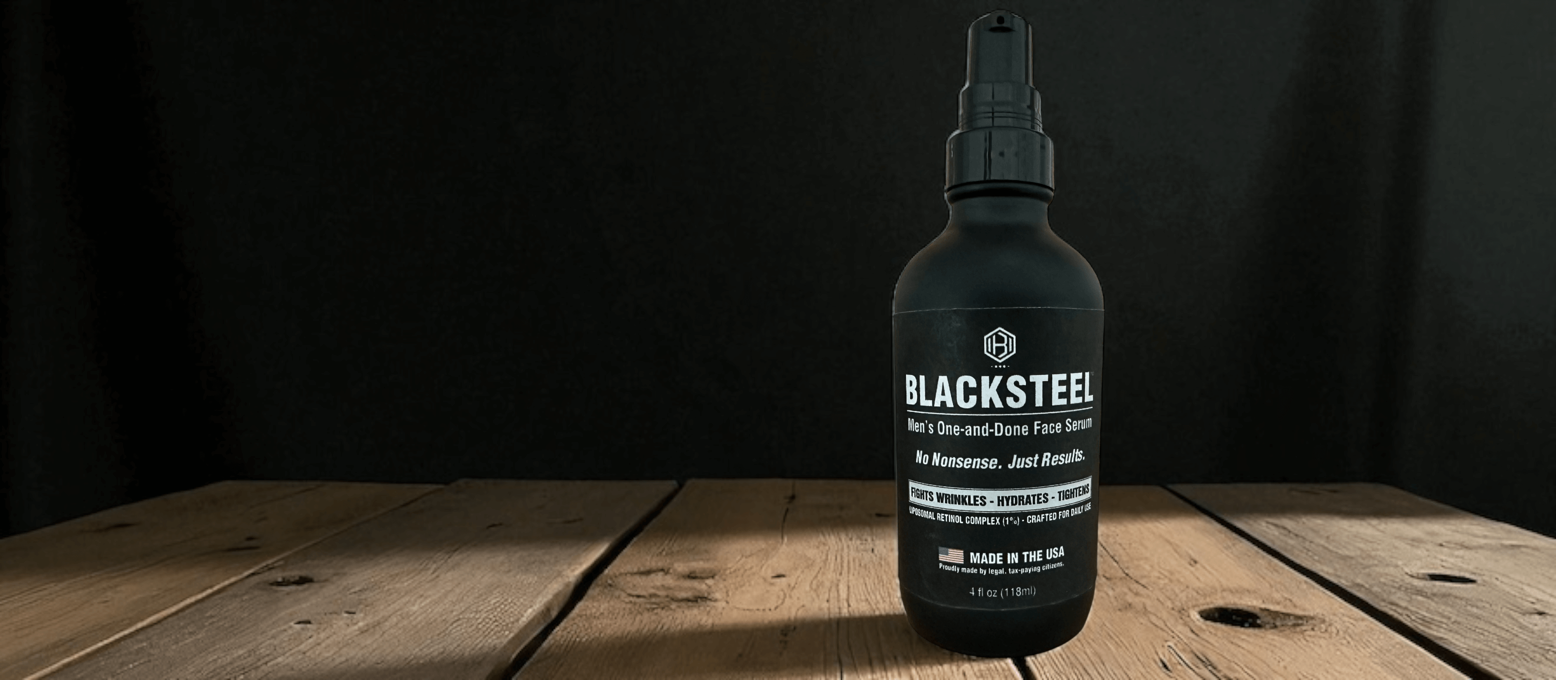 BLACKSTEEL Men's Face Serum hero banner showing matte black bottle and bold tagline on dark background