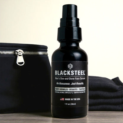 BLACKSTEEL 1 oz. travel size face serum for men shown with toiletry bag and towel