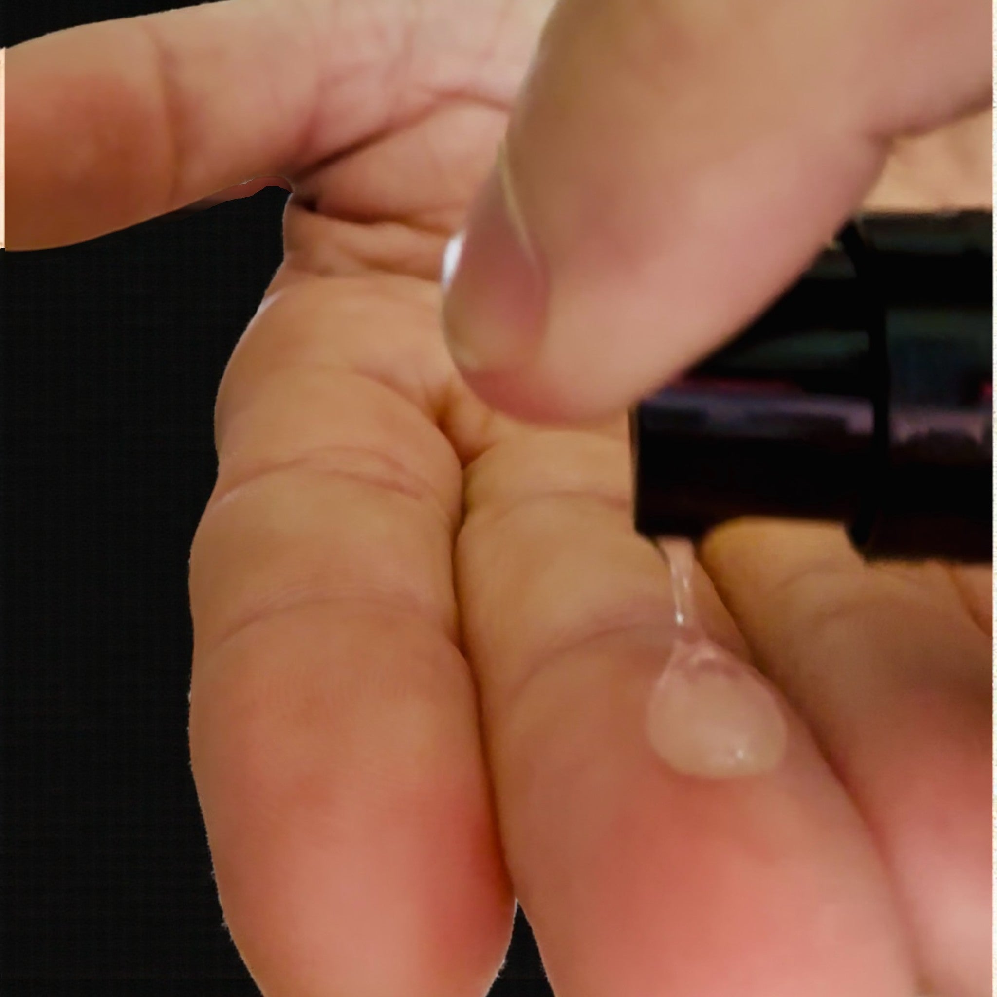 Blacksteel men's face serum being applied to fingers.
